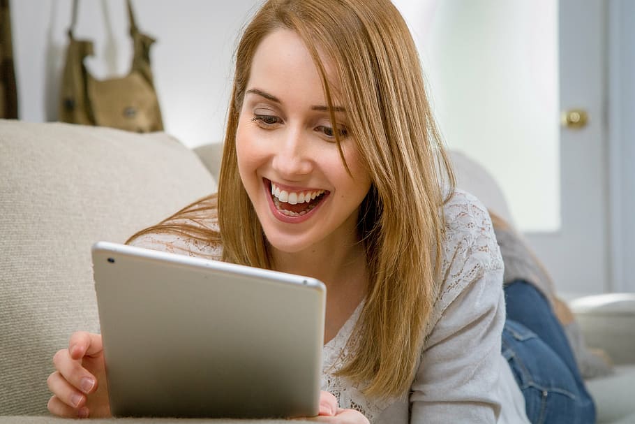 woman, holding, tablet computer, smiling, tablet, electronic, living room, communication, relax, computer