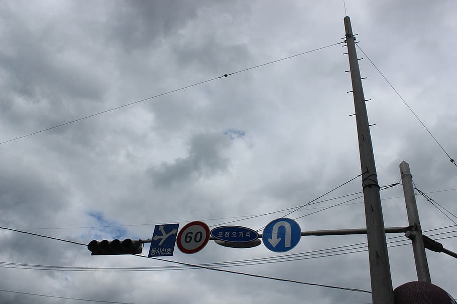 signs, the traffic light, u-turn, cloud - sky, cable, low angle view, sky, electricity, nature, power line