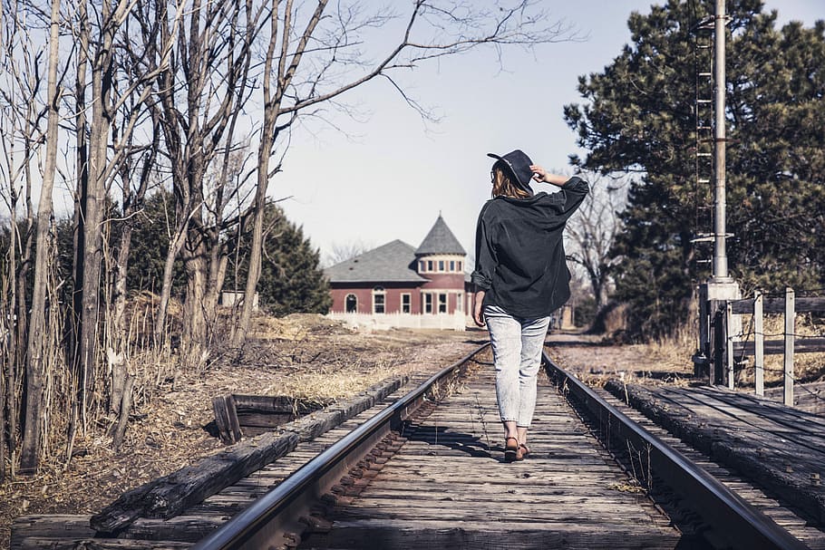 woman, wearing, black, jacket, walking, railway, walking on, people, lazy, hat