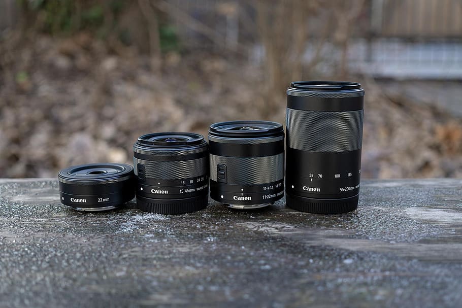 canon lenses, system camera lenses, canon ef-m lens, photography themes, day, technology, table, selective focus, focus on foreground, camera - photographic equipment