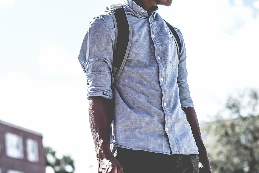 man standing outdoor, guy, man, fashion, clothing, backpack, african american, bokeh, building, plants