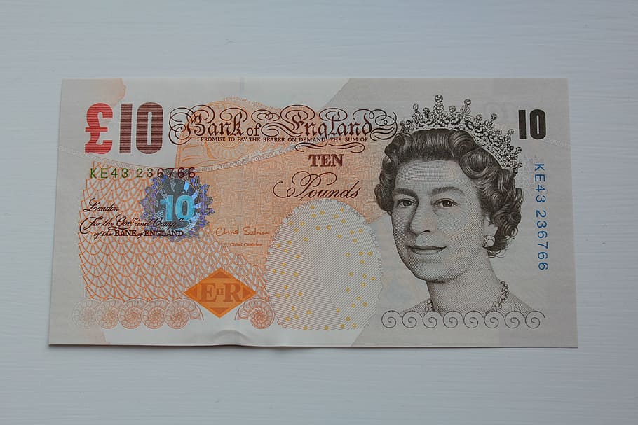 pound, currency, the greenback, human representation, indoors, representation, text, female likeness, studio shot, close-up