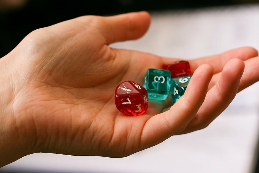 person, holding, red-and-teal dice, dice, hand, game, role-playing game, board game, playing, player