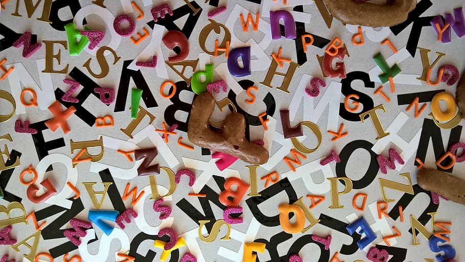 letters, alphabet, alphabet soup, jumble, large group of objects, multi colored, indoors, text, abundance, still life