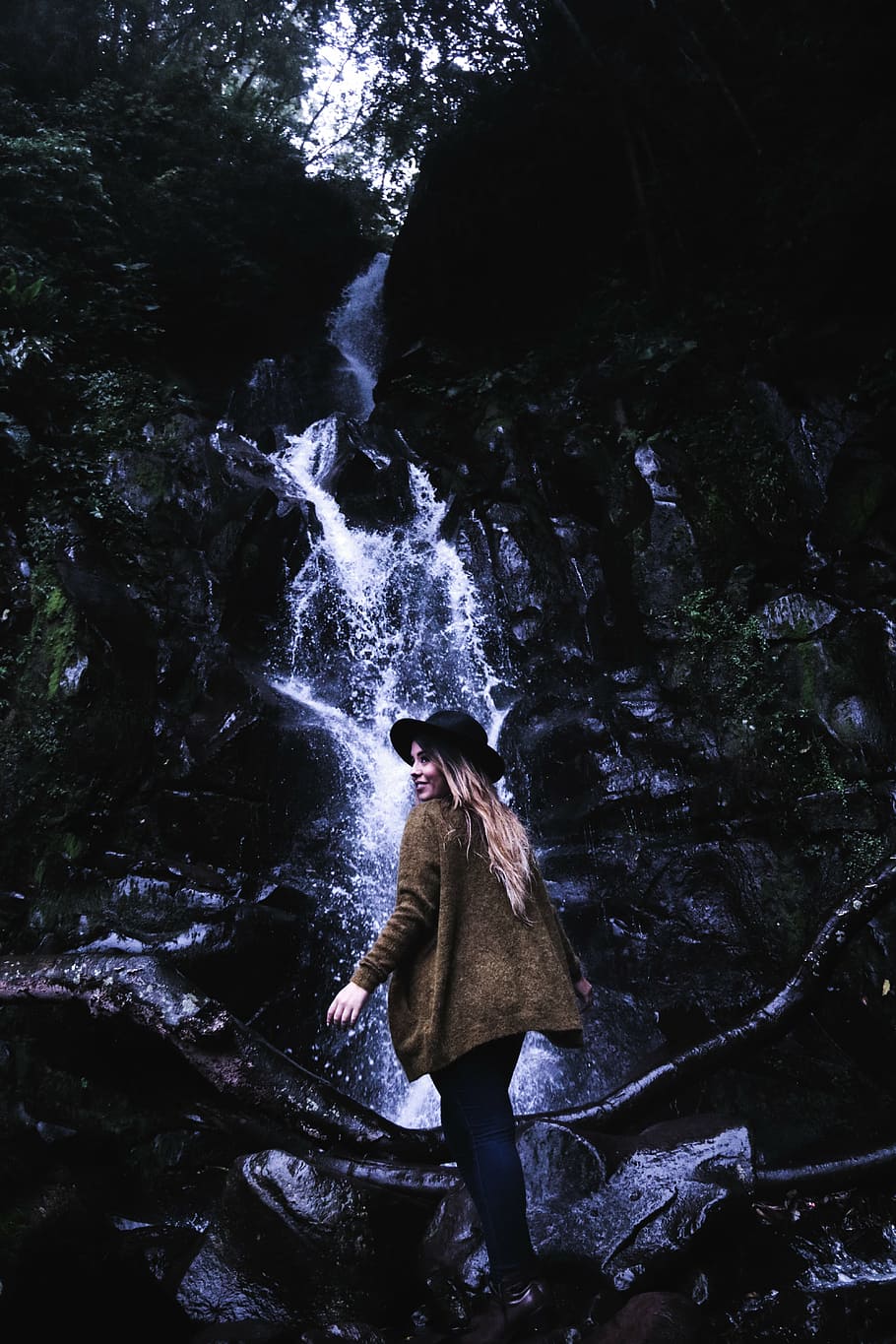 woman, brown, jacket, black, hat, waterfalls, standing, front, water, falls