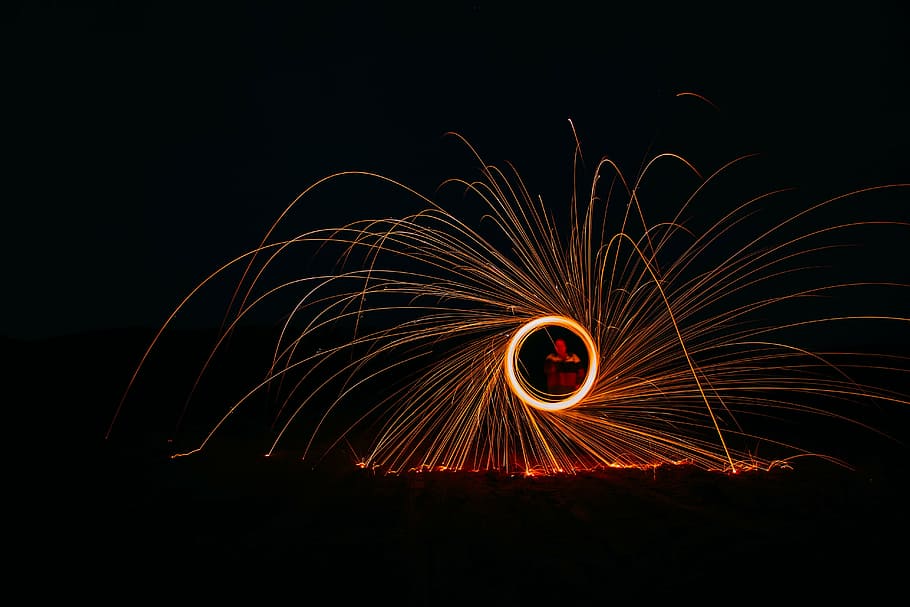 timelapse steelwool photography, person, holding, orange, light, fire, crackers, still, fireworks, show