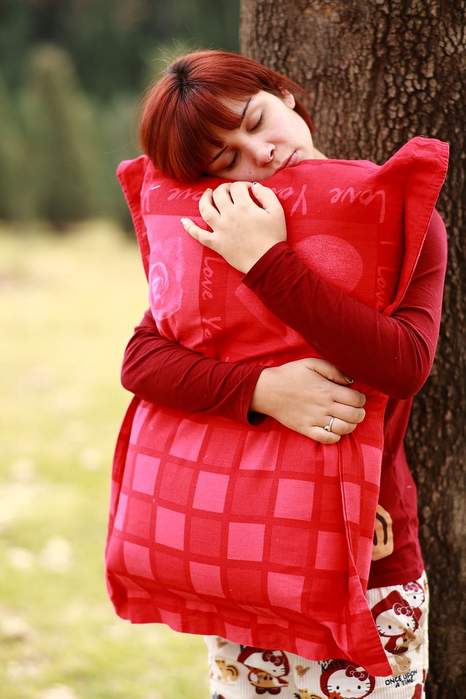 Mujer, abrazos, rojo, almohada, al lado, árbol, durante el día, dormir, sonambulismo, retrato
