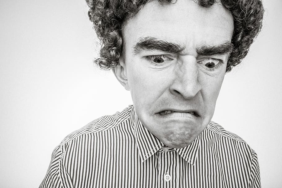 curly-haired man, grumpy face, wearing, stripe, collared, shirt close-up, grayscale photo, curly-haired, man, grumpy