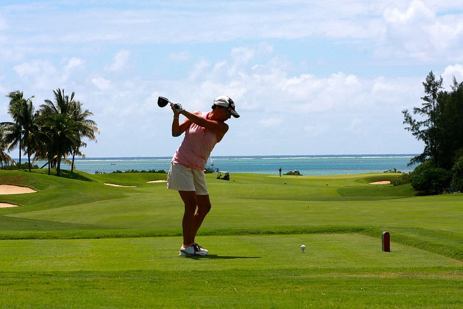 woman, pink, tank, top, matching, white, shorts, playing, golf, blue