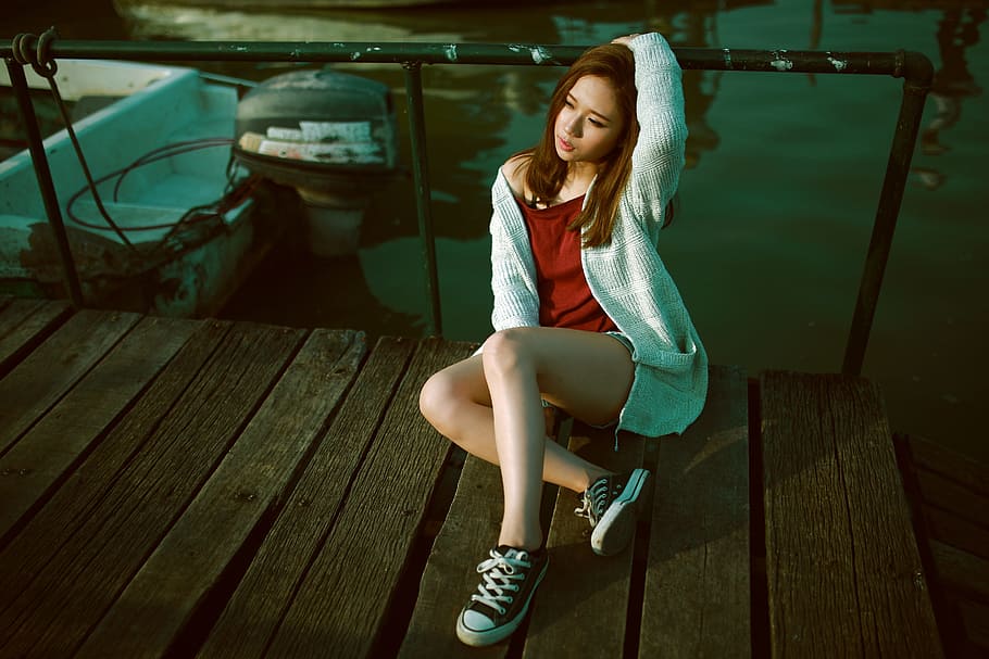 woman, wearing, red, shirt, gray, cardigan, pair, black, low-top sneakers outfit, sitting