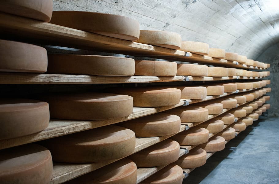 cheese cellar, cheese, keller, mountain cheese, large group of objects, cellar, stack, in a row, shelf, food and drink