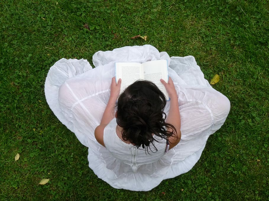 woman, white, dress, sitting, green, grass, reading books, daytime, woman in white, white dress