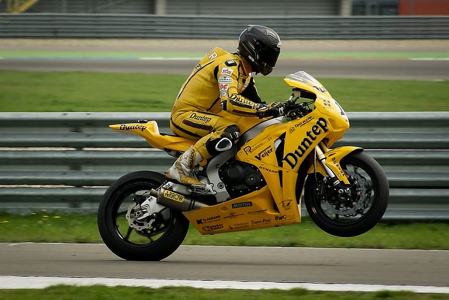 person, driving, yellow, black, sports bike, wearing, racing, suit, helmet, riding