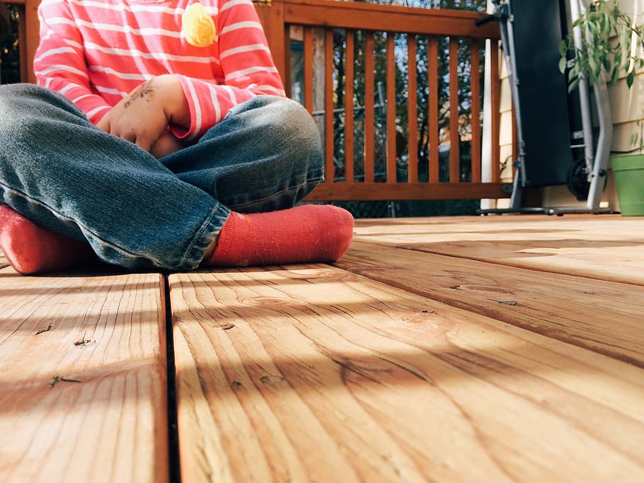 person, sitting, floor, wood, deck, child, kid, porch, backyard, one person