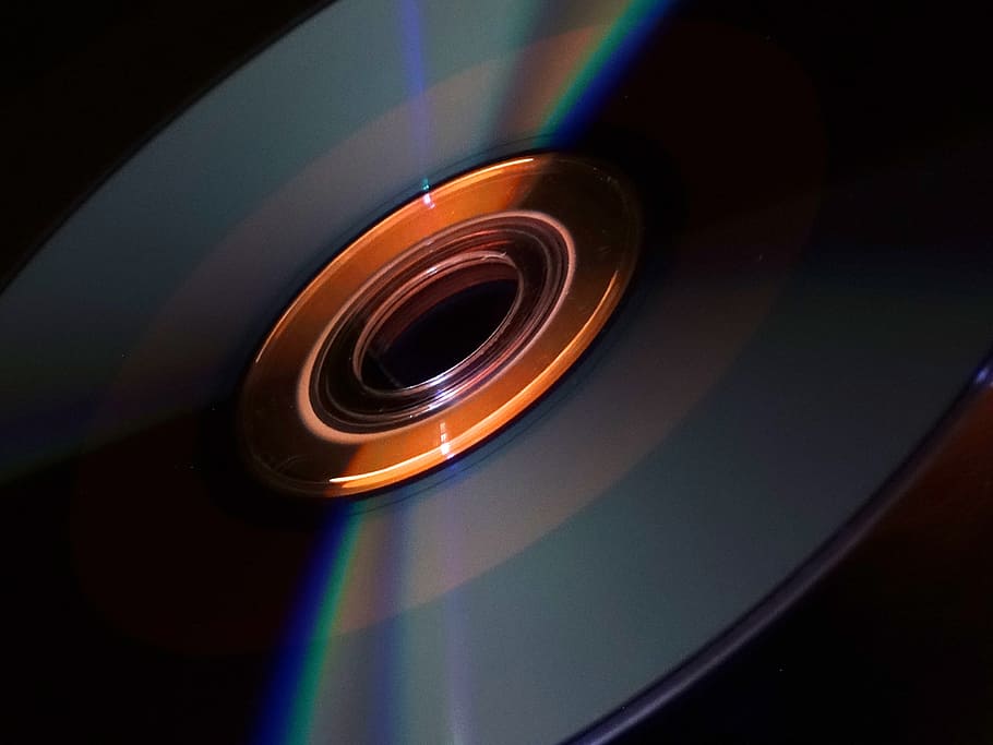 cd, dvd, edge, demarcation, refraction, shiny, glassy, orange, black, disk