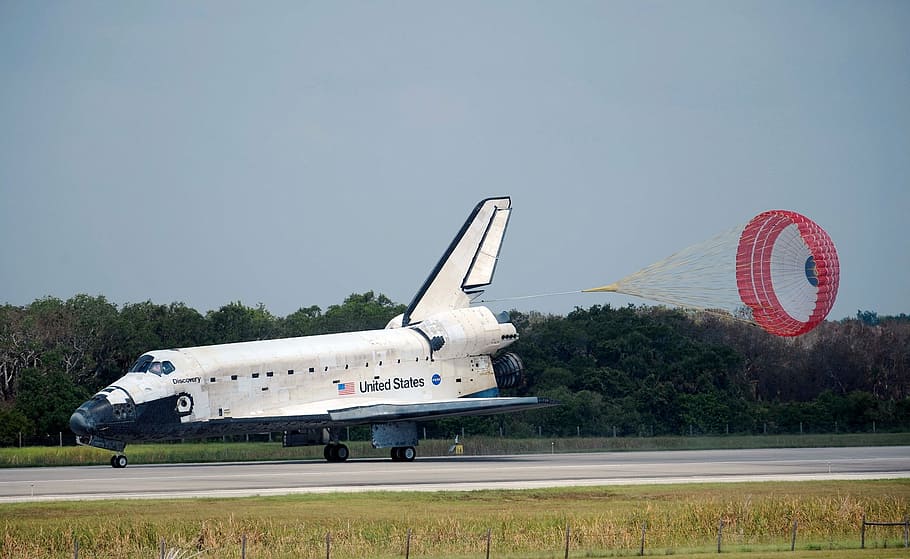 white, airplane, ground, space shuttle, discovery, landing, drag chute, runway, space, astronauts