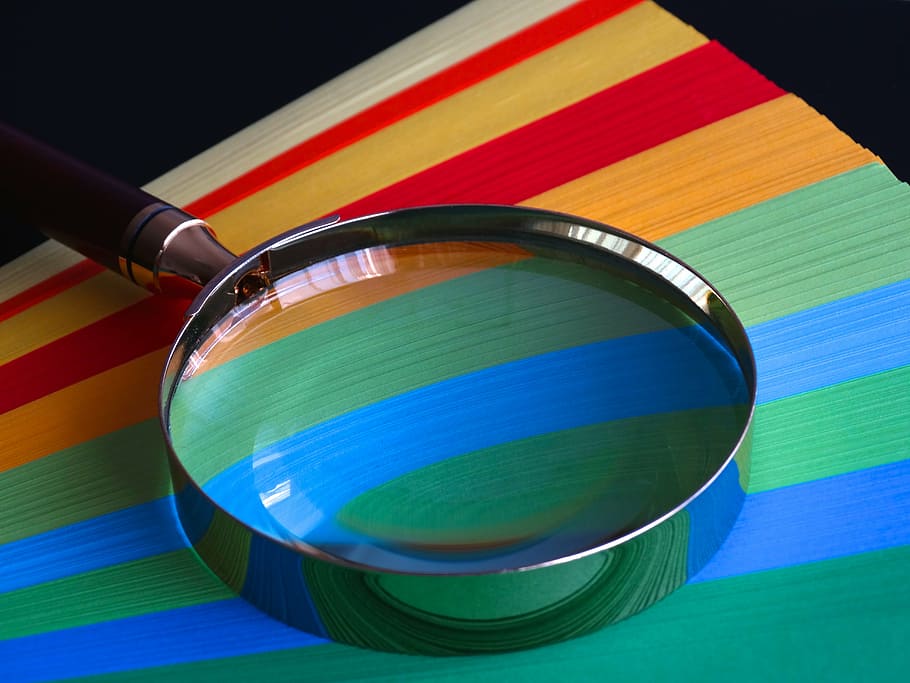 magnifying lens, magnifying glass, quality, paper, paper stack, colored paper, color, colorful, multi colored, close-up