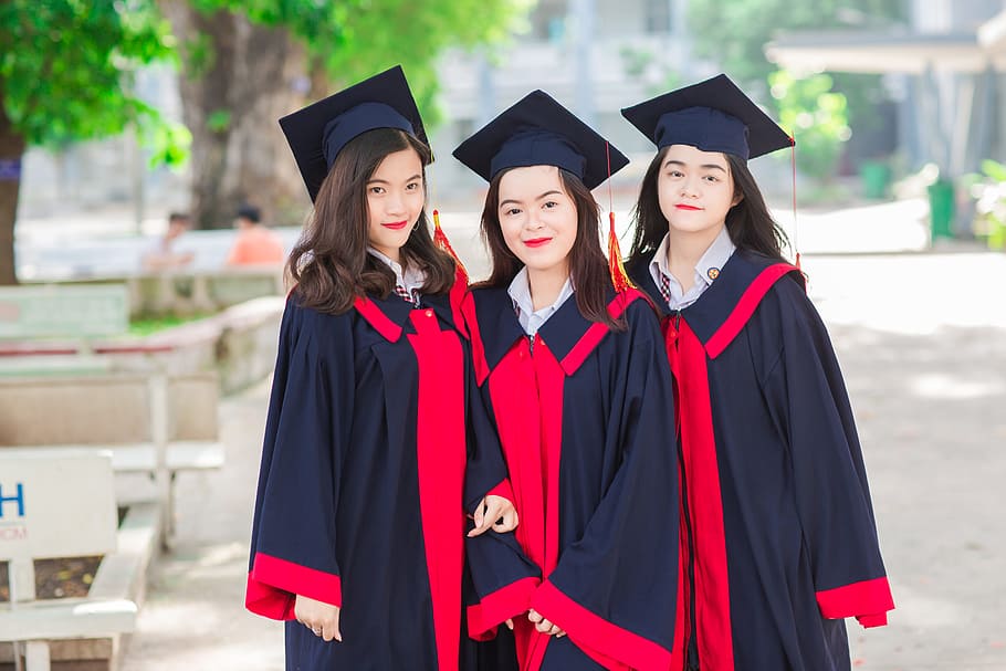 three, women, wearing, black-and-red, academic, dresses, outdoors, friend, student, graduate