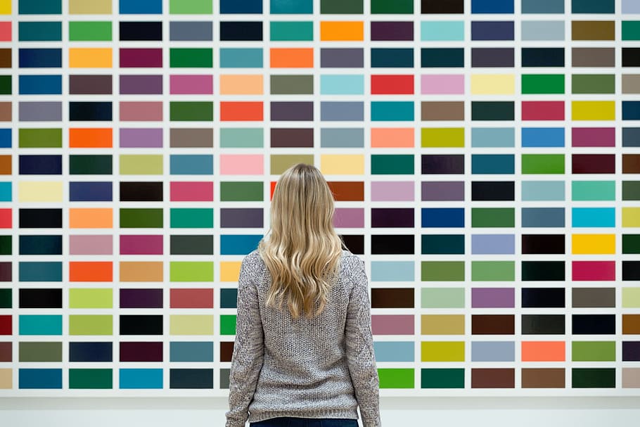 woman, gray, sweatshirt, standing, front, multicolored, wall, colors, rainbow, art