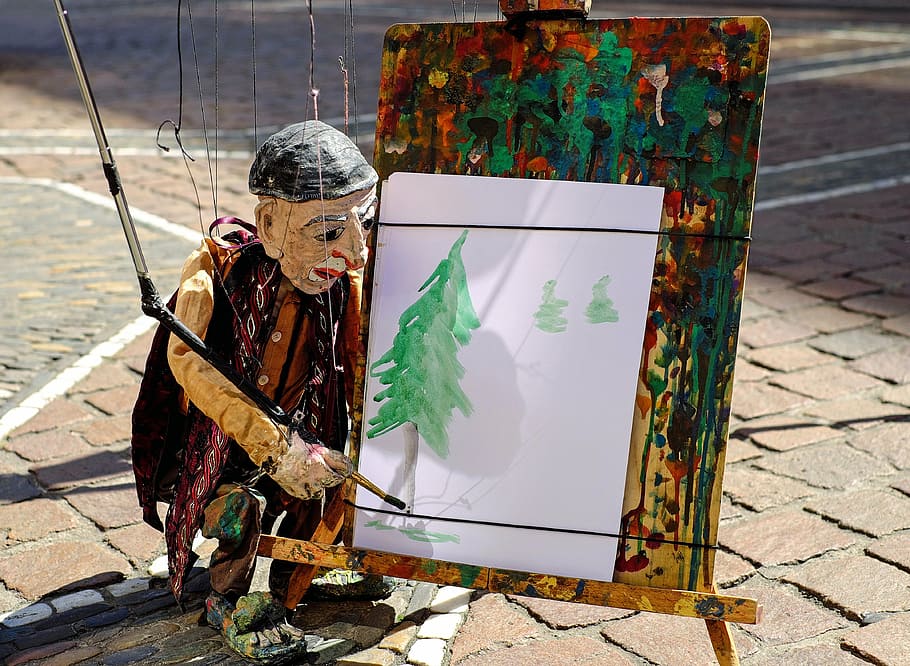 puppet painting pine tree, puppet, figure, artists, paint, puppeteer, road, one person, day, real people