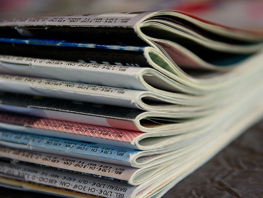 close-up photo, assorted-title magazines, magazines, reading, journals, newspapers, stack, in a row, close-up, large group of objects