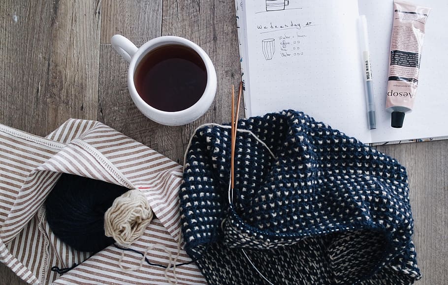 yarn, thread, knitting, clothing, pen, paper, coffee, tea, wooden, table