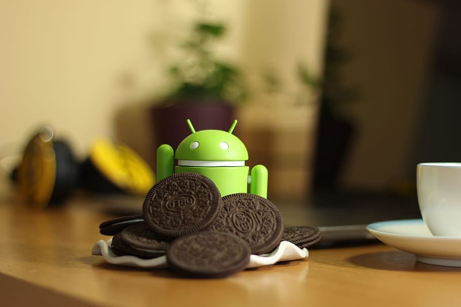 android toy, oreo cookies, table, android, oreo, coffee, indoors, food and drink, selective focus, animal representation