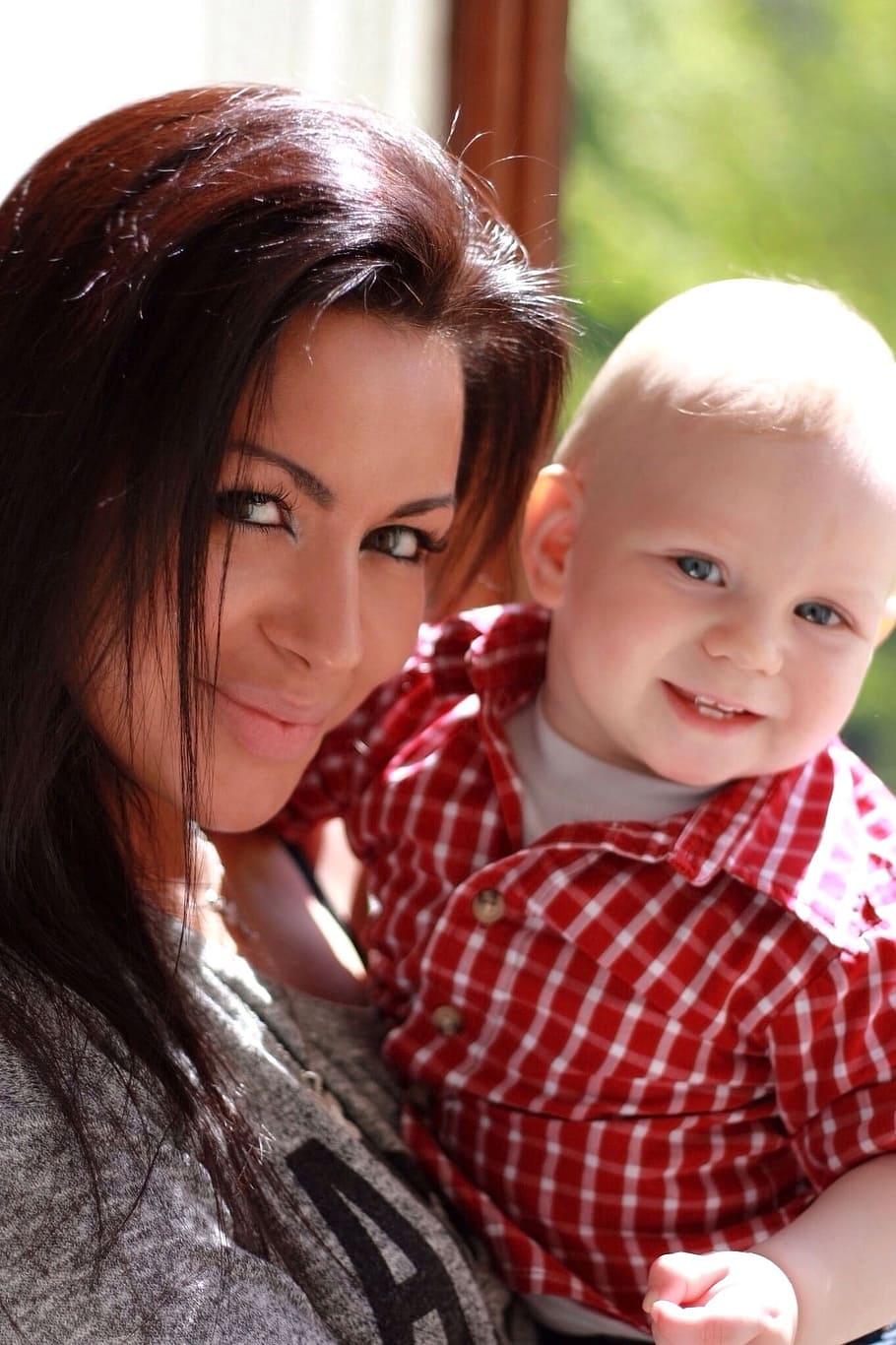 woman, heather, gray, jacket, carrying, baby boy, red-and-white, plaid, button-up shirt, white