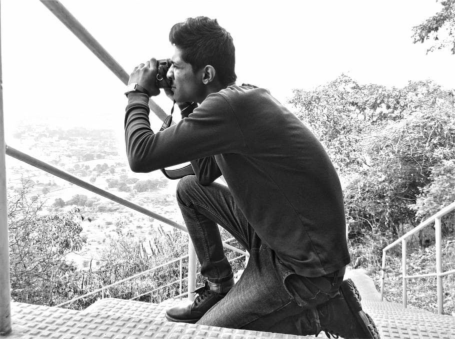 grayscale photo, man, using, dslr camera, kneeling, staircase, take, photographer, photography, guy