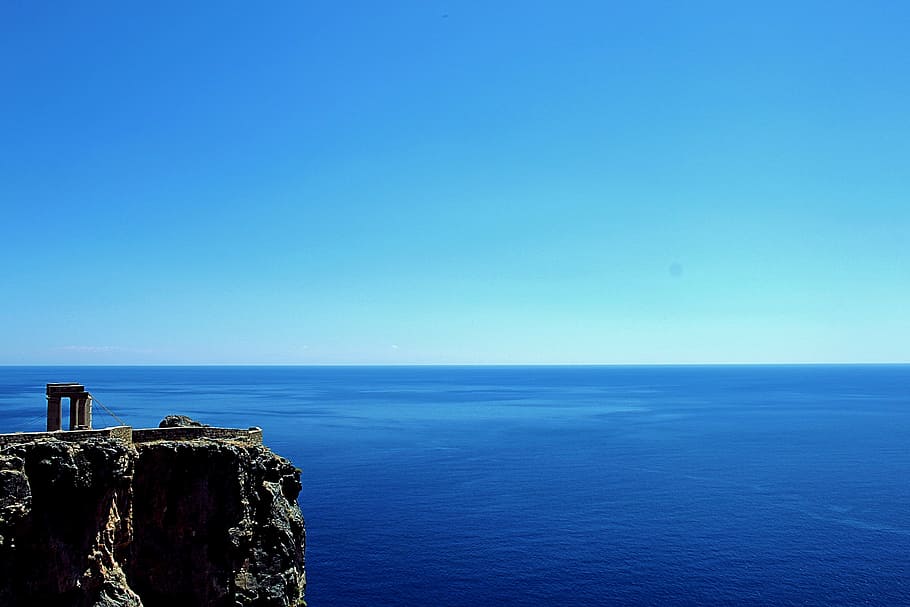 gray, rugged, cliff, blue, calm, body, water, sky, daytime, sea