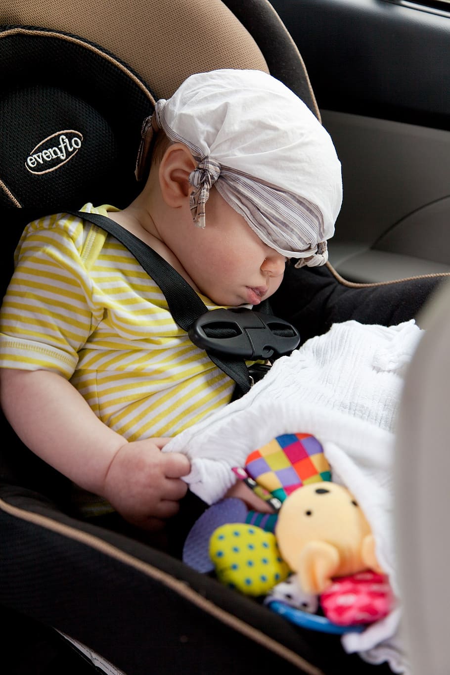 baby, wearing, yellow, white, striped, shirt, sleeping, brown, black, evenflo booster seat