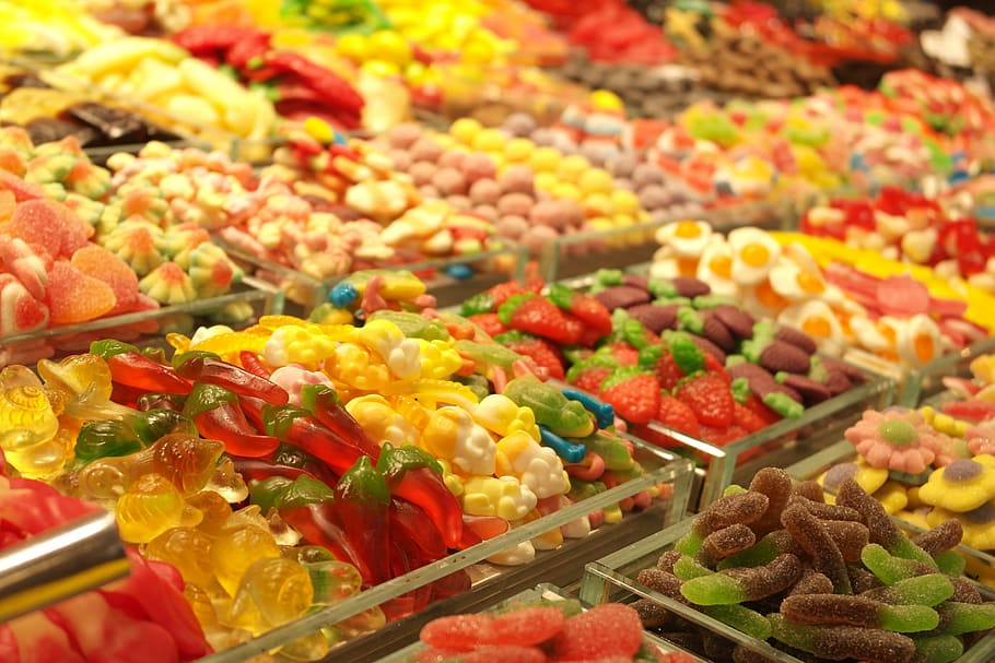 person showing candies, supermarket, candy, green, red, yellow, container, colorful, color, green color