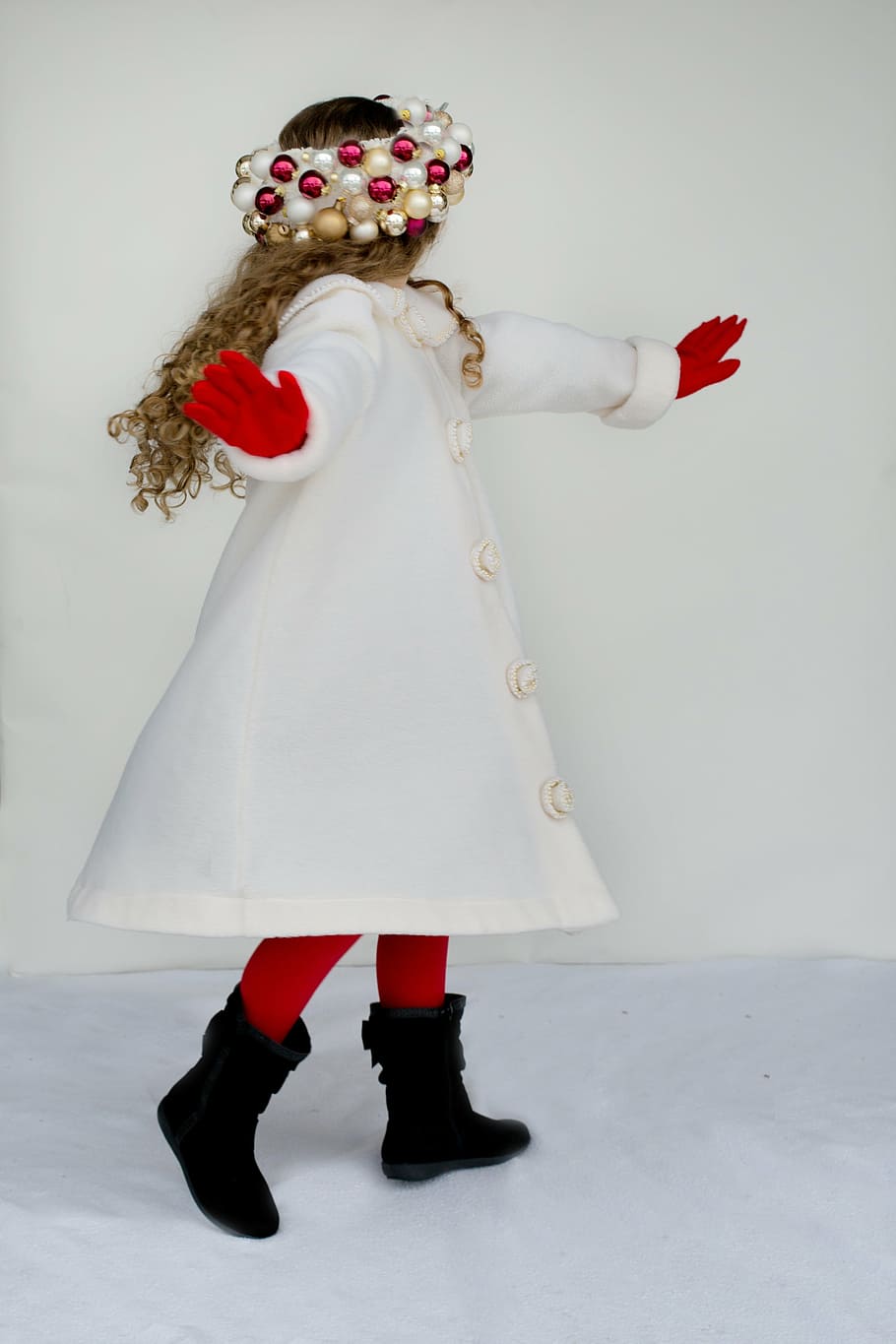 girl, wearing, white, coat, standing, wall, little girl, twirling, dancing, spinning