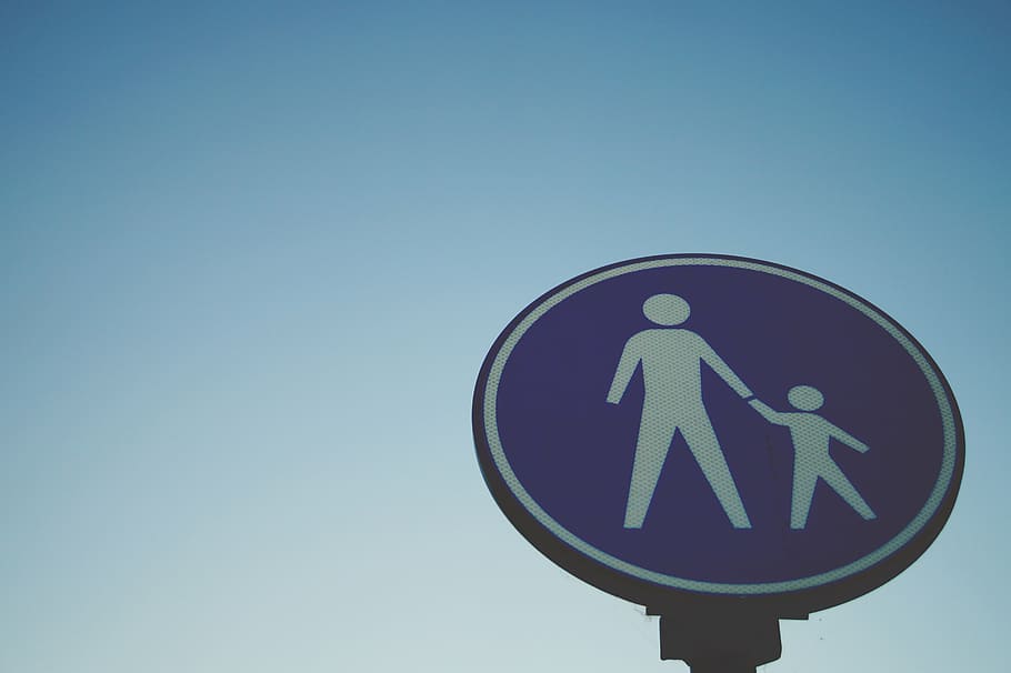 low, angle photo, crossing, signage, sign, parent, child, kid, symbol, blue