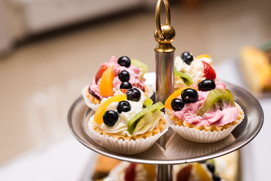 four, tarts, fruit toppings, placed, round, gray, cupcake, stand, selective, focus photo