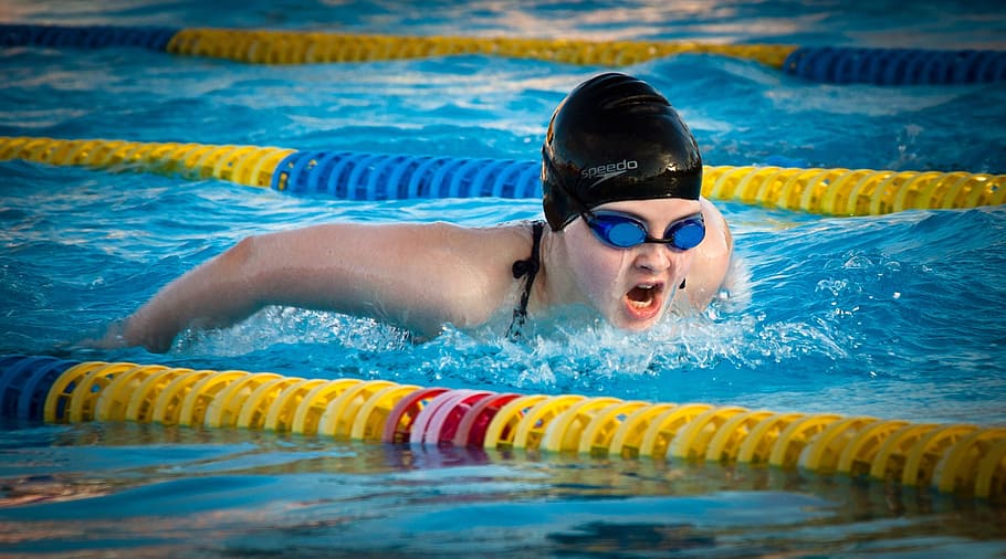 person, wearing, black, swim, cap, blue, goggles, swimming, butterfly, pool