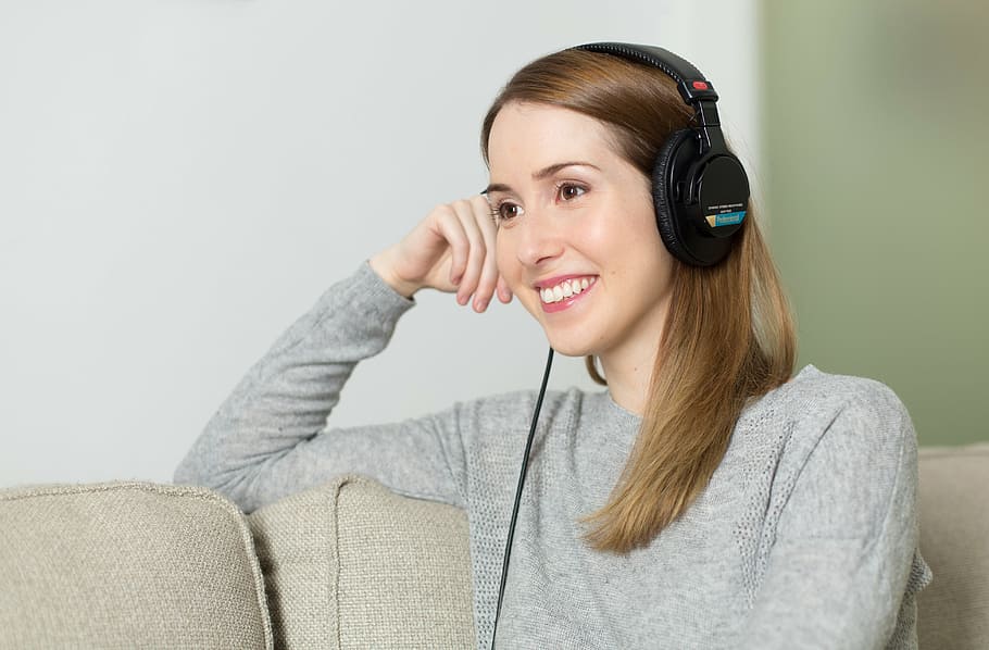 woman, wearing, black, corded, headphones, sitting, sofa, girl, music, listen to