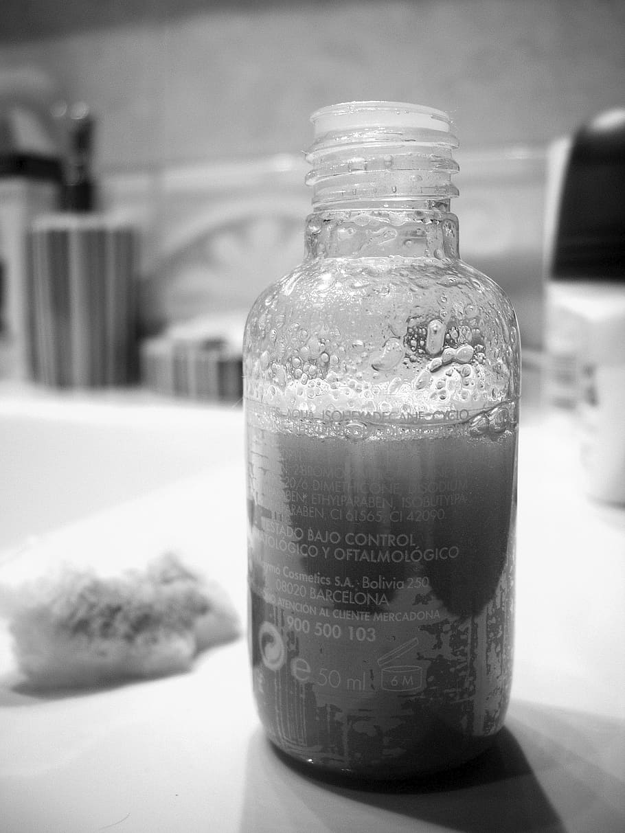 grayscale photo, plastic bottle, shampoo, bottle, black white, container, focus on foreground, close-up, food and drink, jar