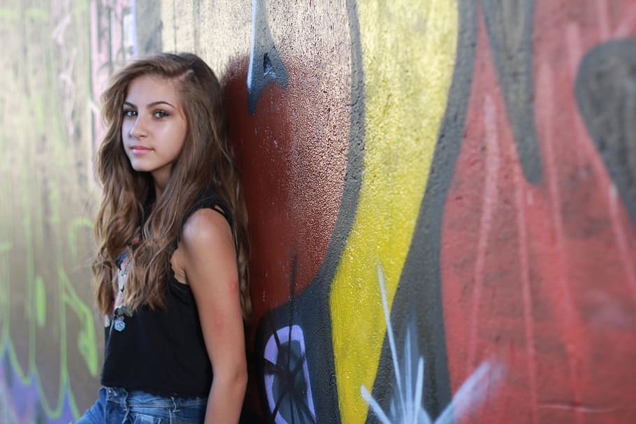 woman, wearing, black, tank, top, leaning, wall, red wall, young, teenager