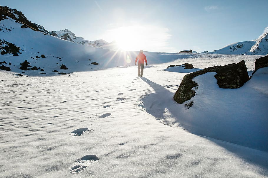 person, walking, snow field, daytime, mountain, highland, cloud, sky, summit, ridge