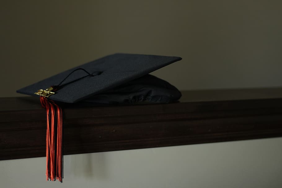 graduation, cap, hat, black, orange, celebration, indoors, black color, education, still life