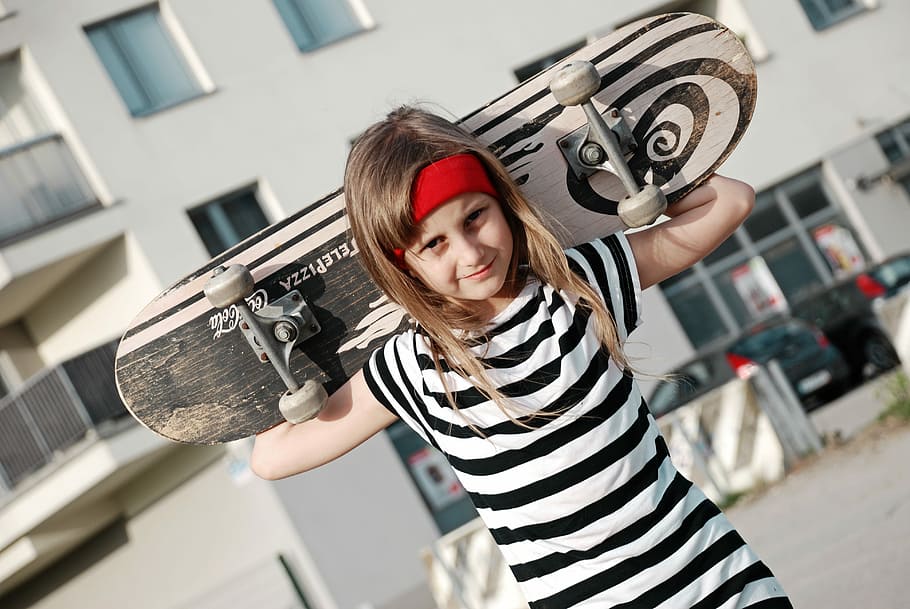 girl carrying skateboard, girl, wheels, skateboard, sports, road, skate, posture, smile, hair