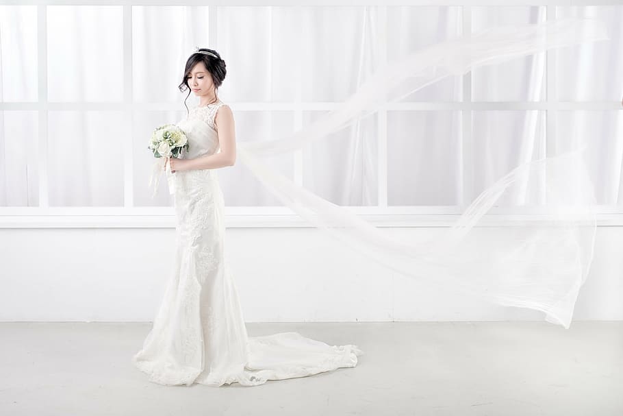 woman, standing, wearing, white, wedding gown, holding, flower bouquet, bride, get married, hairstyle