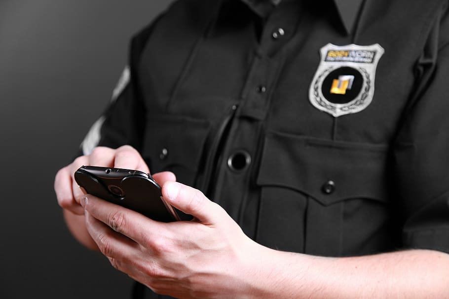 sheriff holding smartphone, bodyworn, body camera, police body camera, law enforcement, cops, law enforcing, policeman, police officer, technology