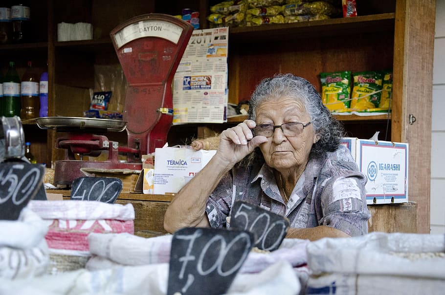 woman, holding, eyeglasses, front, sack, elderly woman, seller, market, merchant, lady