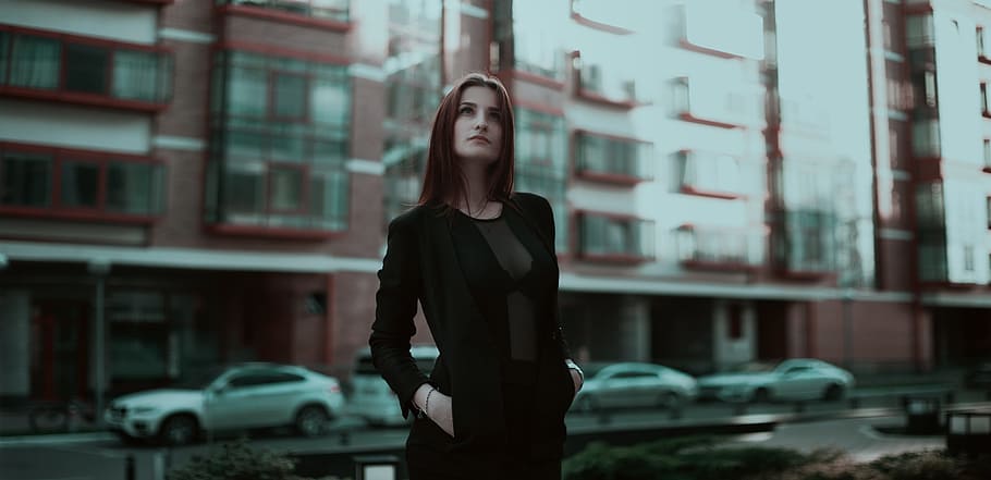 woman, wearing, black, long-sleeved, dress, standing, building, daytime, business lady, business