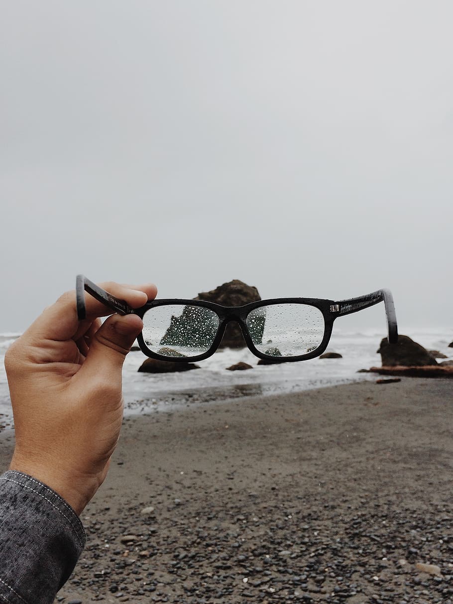 person, holding, black, framed, eyeglasses, glasses, beach, rain, weather, hand