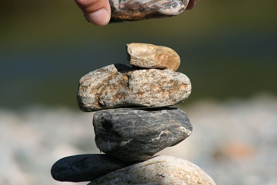 stones, pebble, river, rock, solid, human body part, human hand, rock - object, one person, hand