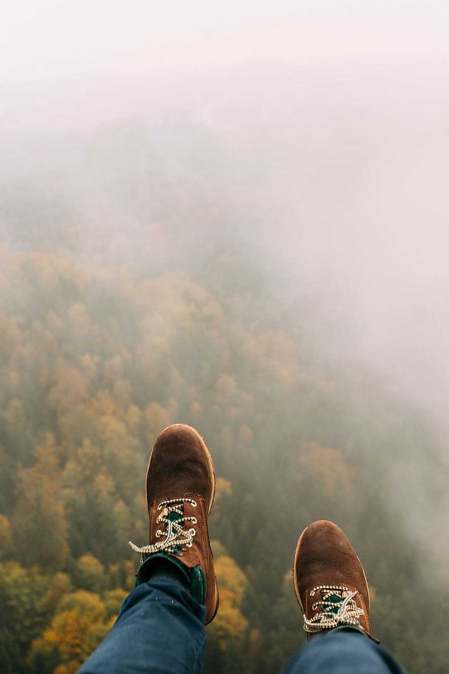 person, wearing, brown, shoes, blue, jeans, sneakers, top, foggy, mountain