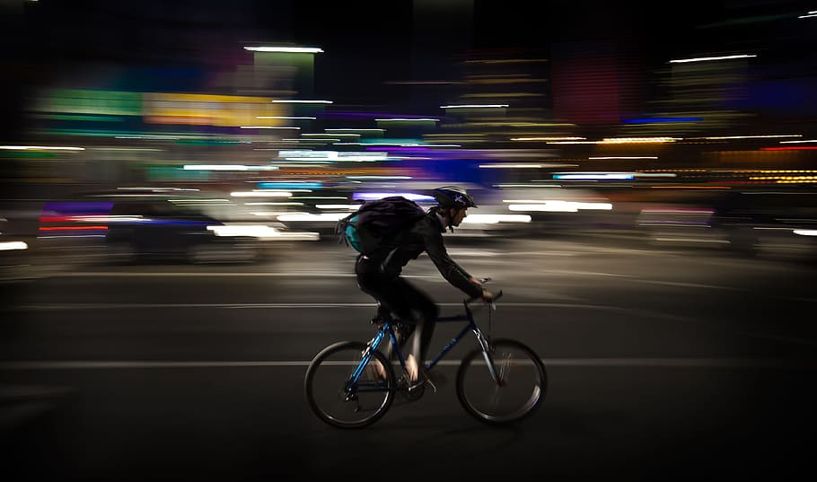 timelapse photography, man, rigid, bicycle, courier, night, panning, warsaw, poland, colorful